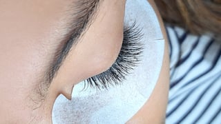 Close up of eye with eyelash extensions on dark skin