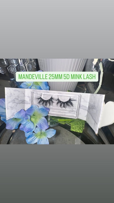 Mandeville 25mm 5D mink lash product display with false eyelashes in packaging, blue and green flowers, and marble textured background